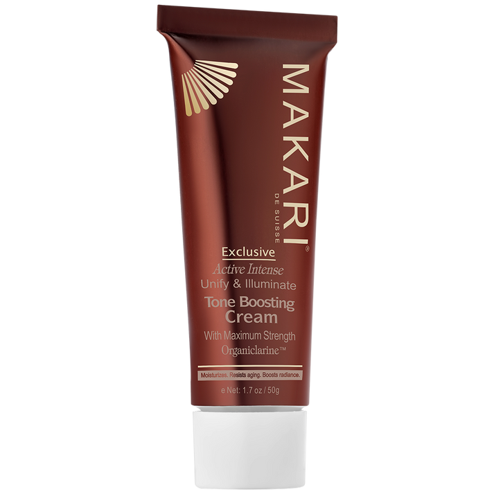 Makari Exclusive Active Intense Tone Boosting Cream in a brown squeeze tube with white cap, featuring gold and beige design elements.