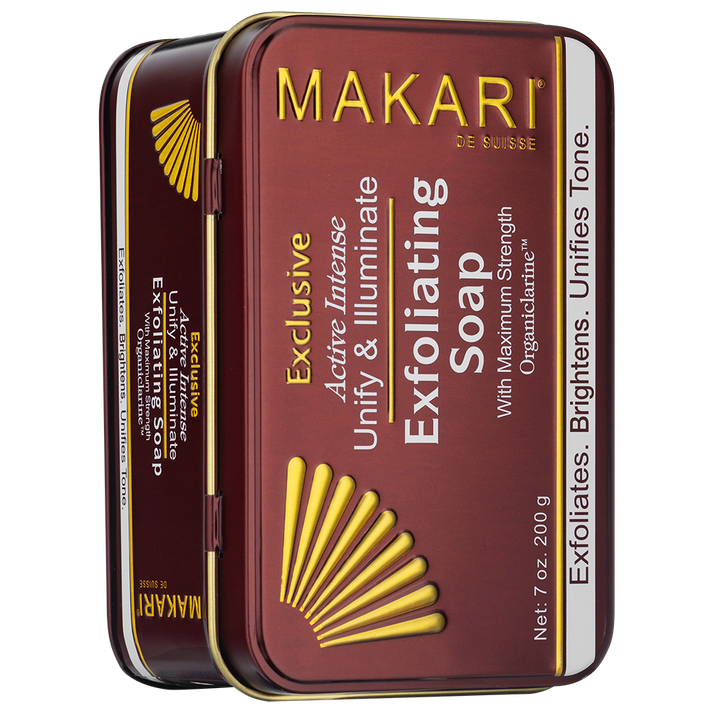Makari Exclusive exfoliating soap in a rectangular metal tin with a maroon and gold design, featuring yellow fan graphic and product details.