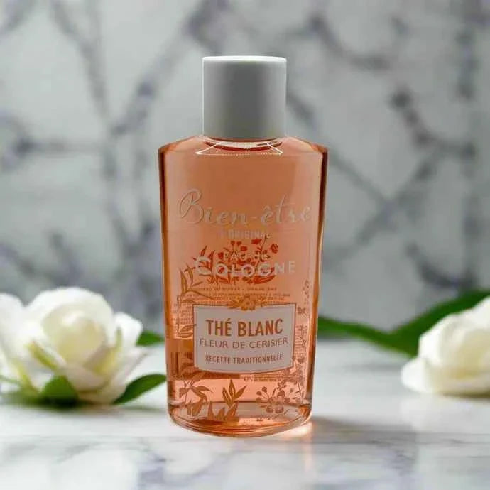Bien-Être White Tea and Cherry Blossom Eau de Cologne bottle with white cap and floral label, 250 ml.