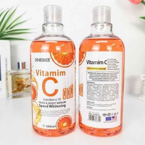 Dr. Meinaier Vitamin C Face & Body Serum bottle, 500ml, with bright orange label and pump dispenser for skincare.