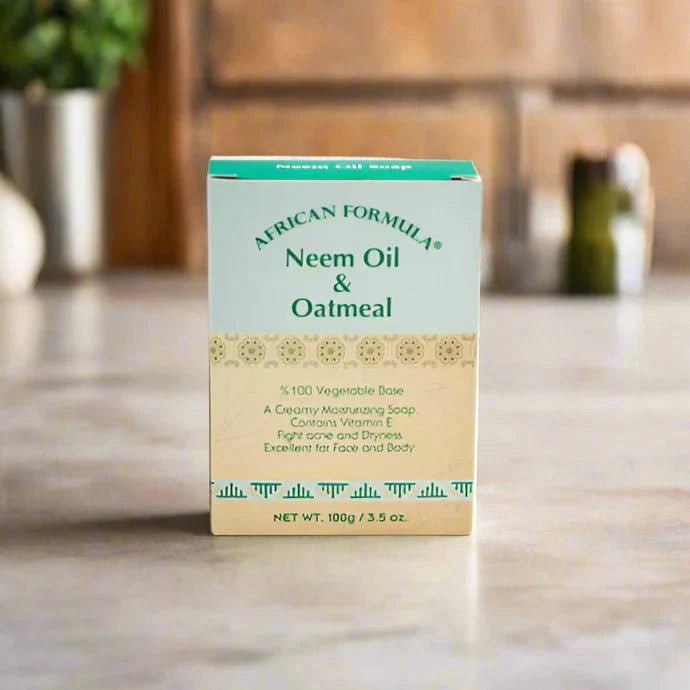 African Formula Neem & Oatmeal Soap 3.5 oz bar with natural ingredients, featuring a white soap with embossed branding on top.