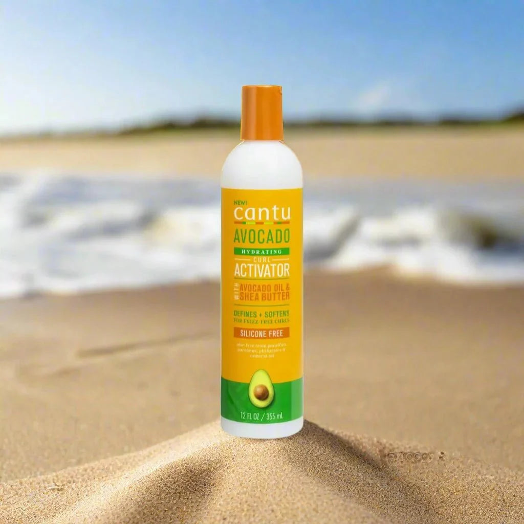 Cantu Avocado Curl Activator Cream 12oz jar with creamy texture, designed for defining and moisturizing curly hair.