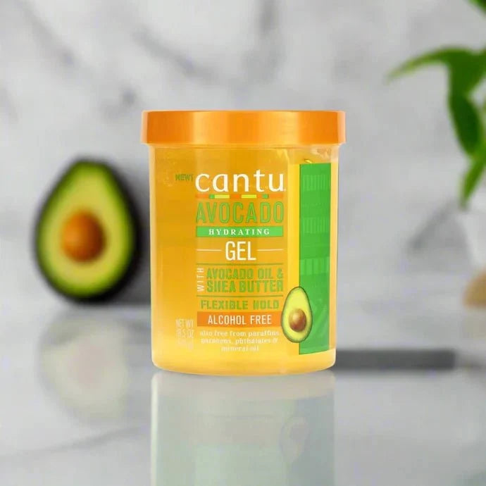 Cantu Avocado Styling Gel 18.5 oz in a clear jar showing the gel's smooth, glossy texture with avocado label details.