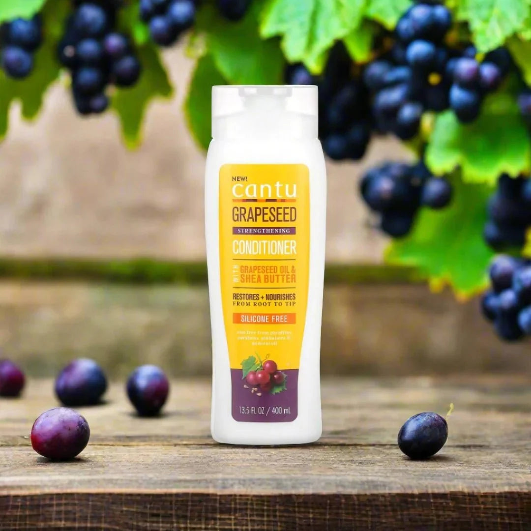 Cantu Grapeseed Strengthening Conditioner in 13.5 oz bottle, creamy conditioner for strengthening and nourishing hair.