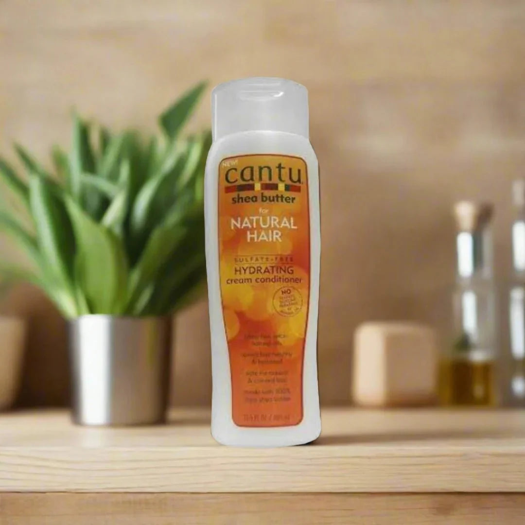 Cantu Natural Hair Sulfate-Free Hydrating Cream Conditioner in 13.5 oz bottle, showing the conditioner tube with label and product details.