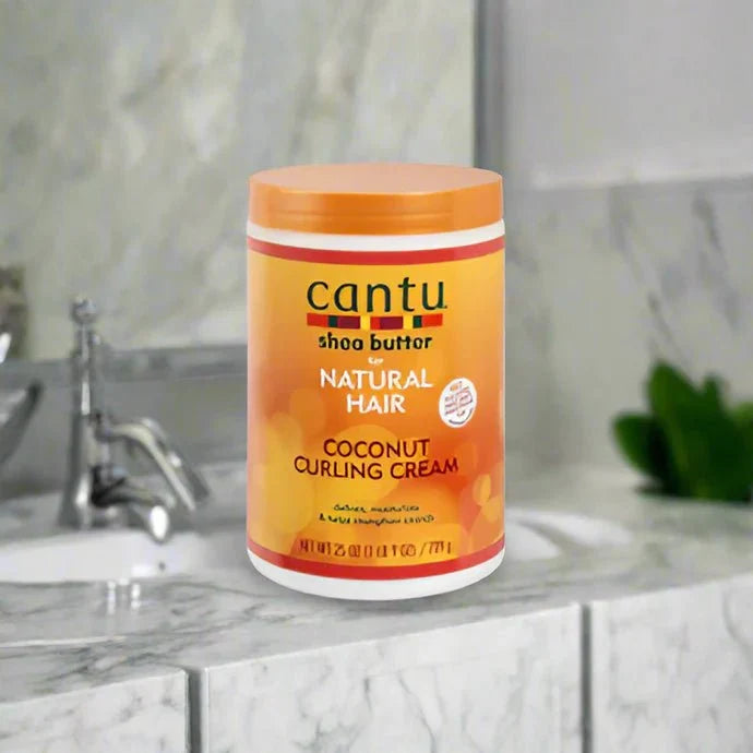 Cantu Shea Butter Coconut Curling Cream in 25 oz jar, showing the product label and creamy texture for defining curly hair.