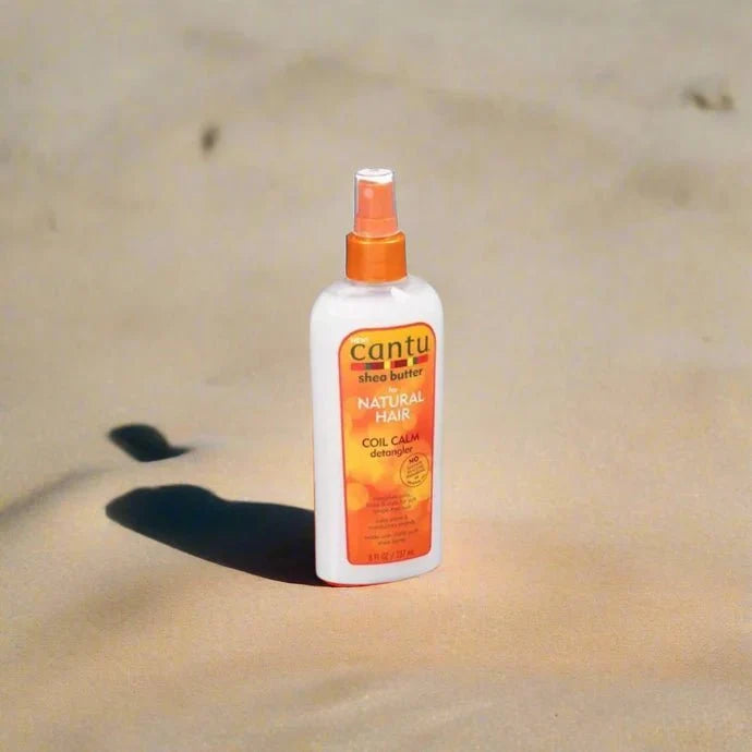 Cantu Shea Butter Coil Calm Detangler 8oz bottle with label, designed for detangling curly and coily hair types.