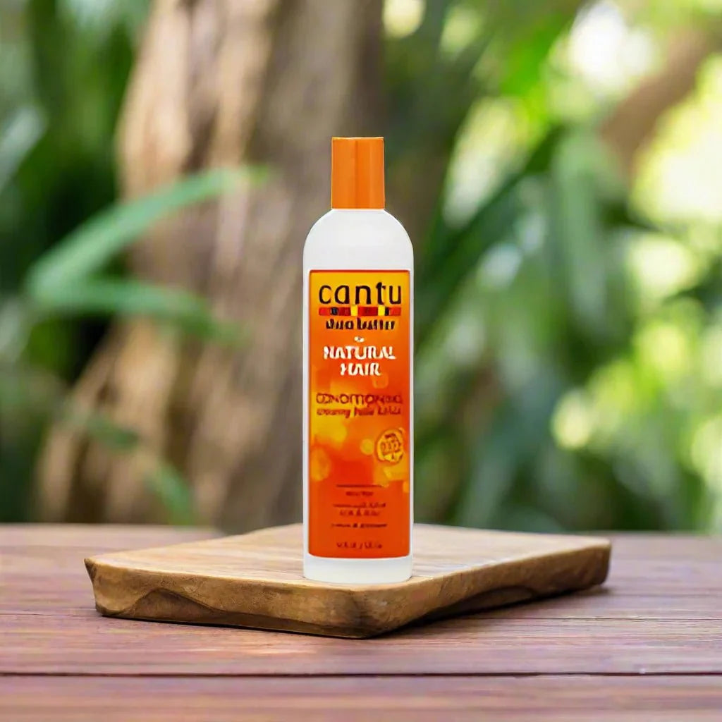 Cantu Shea Butter Conditioning Lotion 12oz bottle with creamy white lotion visible, designed for nourishing and moisturizing hair and skin.