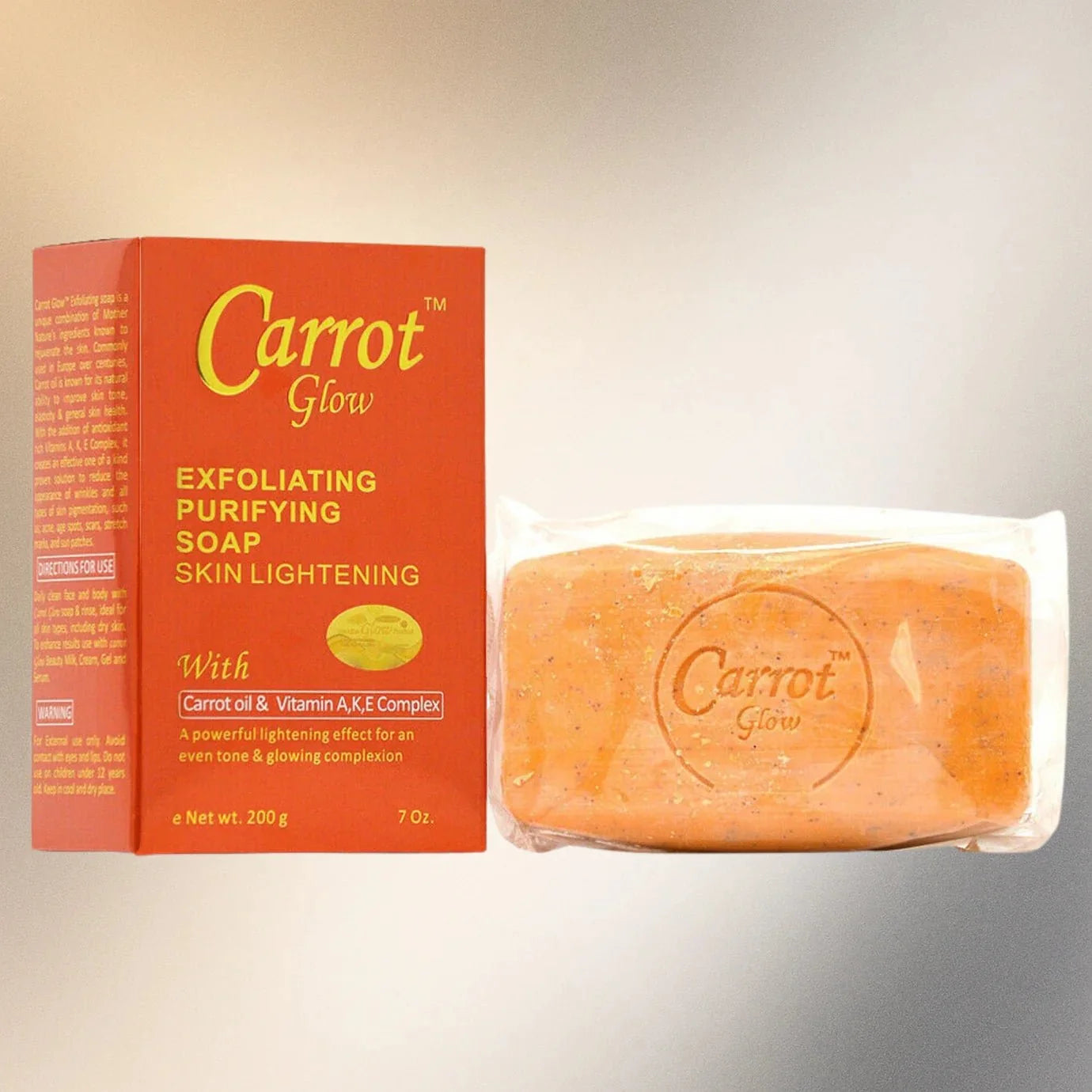 Carrot Glow Purifying Soap with Carrot Oil in a 7 oz bar, natural skincare by Bazarora, showing the soap's fresh orange color and packaging.