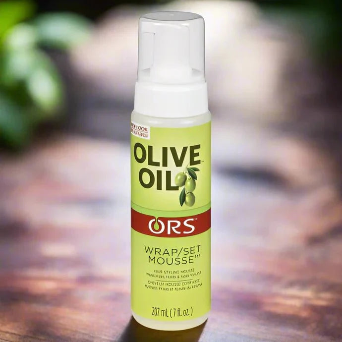 ORS Olive Wrap and Set Mousse 7 oz bottle, featuring a white and green label with a flip-top cap, designed for hair styling.